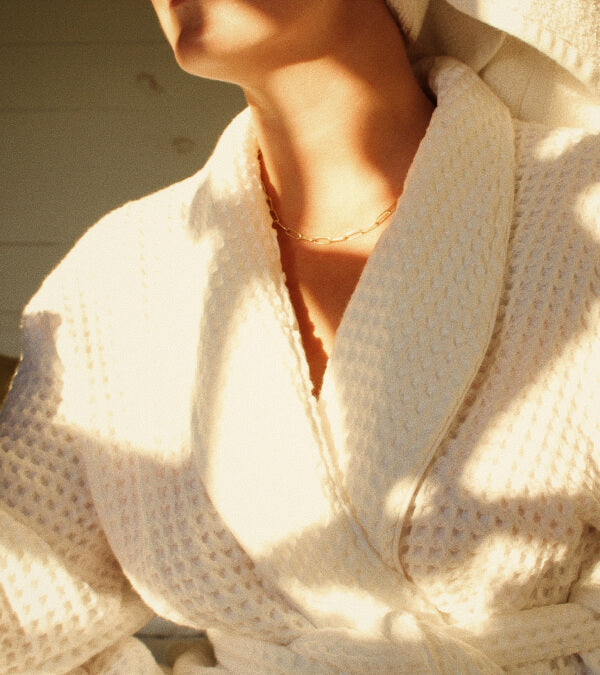 Close up of a woman wearing a white waffe robe