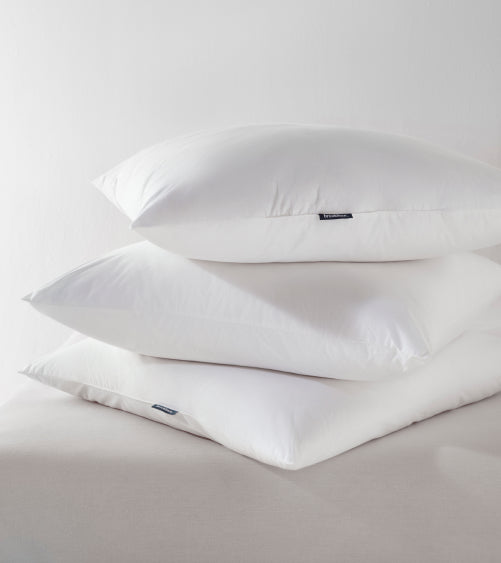 three pillows stacked on top of another
