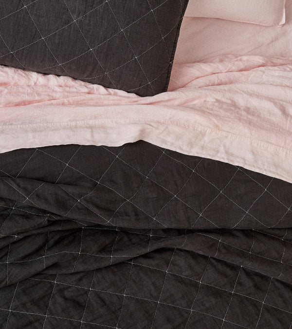 Pink linen sheets with a grey linen quilt